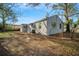 Exterior backyard view of gray single story home with a fenced in yard at 3710 W Griflow St, Tampa, FL 33629