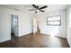 Spacious bedroom with a ceiling fan, wood floors, and natural light from the windows at 3710 W Griflow St, Tampa, FL 33629