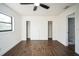 Bedroom with hardwood floors, closet, window, and ceiling fan at 3710 W Griflow St, Tampa, FL 33629