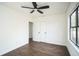 Bright bedroom featuring hardwood floors, a ceiling fan, and a window with natural light at 3710 W Griflow St, Tampa, FL 33629