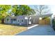 Side view of a light gray home, showing a covered parking area and manicured lawn at 3710 W Griflow St, Tampa, FL 33629