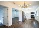 Modern kitchen featuring stainless steel appliances, white cabinetry, and view to living area at 3710 W Griflow St, Tampa, FL 33629