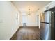 Open eat-in kitchen with stainless steel refrigerator and wood flooring at 3710 W Griflow St, Tampa, FL 33629