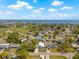 Aerial view of a neighborhood showcasing a modern house with lush greenery and beautiful bay view at 3860 Whiting Se Dr, St Petersburg, FL 33705