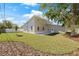 Backyard view of the home showcasing the large yard and well-maintained lawn at 3860 Whiting Se Dr, St Petersburg, FL 33705