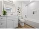 Bathroom featuring a white vanity, framed mirror and a shower-tub combination at 3860 Whiting Se Dr, St Petersburg, FL 33705