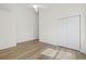 Large bedroom with wood-look floors, ceiling fan, and closet for ample storage at 3860 Whiting Se Dr, St Petersburg, FL 33705