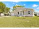 Charming single-Gathering home showcasing a spacious lawn, a wide garage, and a stylish front door at 3860 Whiting Se Dr, St Petersburg, FL 33705