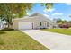 Beautiful home featuring a well-maintained lawn, wide driveway, and modern architectural design at 3860 Whiting Se Dr, St Petersburg, FL 33705