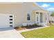 Exterior home view, highlighting a modern garage, front door, and professionally landscaped walkway at 3860 Whiting Se Dr, St Petersburg, FL 33705