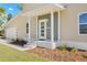 Exterior home showcasing the front entryway with modern architectural design and manicured landscaping at 3860 Whiting Se Dr, St Petersburg, FL 33705