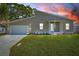 Charming single-story home features a modern design, well-manicured lawn, and an attached two-car garage at 3860 Whiting Se Dr, St Petersburg, FL 33705