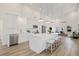 Bright kitchen boasts stainless appliances, white cabinets, a center island with seating, and an open floor plan at 3860 Whiting Se Dr, St Petersburg, FL 33705
