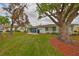 Lush backyard with mature trees, providing ample shade and privacy at 401 Dorchester Pl # 69, Sun City Center, FL 33573