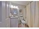 Bathroom featuring modern fixtures, granite countertop, and a shower with decorative curtain at 401 Dorchester Pl # 69, Sun City Center, FL 33573