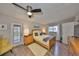 Light filled bedroom with ceiling fan, wood floors and access to a private outdoor patio at 401 Dorchester Pl # 69, Sun City Center, FL 33573