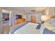 Spacious bedroom with wood floors, closet space, and warm lighting at 401 Dorchester Pl # 69, Sun City Center, FL 33573