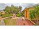 Inviting front yard with mature tree, walkway leading to front door, and manicured landscaping at 401 Dorchester Pl # 69, Sun City Center, FL 33573