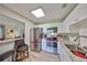Modern kitchen with stainless steel appliances, white cabinets, and granite countertops at 401 Dorchester Pl # 69, Sun City Center, FL 33573