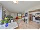 Bright living room featuring wood floors, white walls, modern furniture, and an open-concept kitchen at 401 Dorchester Pl # 69, Sun City Center, FL 33573