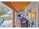 Enclosed sunroom with wood ceiling, tile flooring, and large sliding windows at 401 Dorchester Pl # 69, Sun City Center, FL 33573
