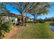 Expansive backyard with mature trees and manicured lawn, perfect for outdoor living and entertaining at 412 Pinewood Dr, Oldsmar, FL 34677