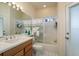 Full bathroom with shower-tub combo, vanity, sink and mirror with vanity lighting at 412 Pinewood Dr, Oldsmar, FL 34677