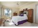 Comfortable bedroom featuring a king-sized bed, a ceiling fan, and natural light from the large window at 412 Pinewood Dr, Oldsmar, FL 34677