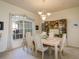 Bright dining room with a chandelier, a large window, and display cabinet at 412 Pinewood Dr, Oldsmar, FL 34677
