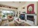 Bright living room with lake views, fireplace, comfortable seating, and a colorful rug at 412 Pinewood Dr, Oldsmar, FL 34677