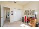 Bright office with a red chair, a desk with drawers, closet and decor items at 412 Pinewood Dr, Oldsmar, FL 34677
