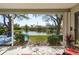 Screened in patio with a lovely view of the lush greenery and serene pond at 412 Pinewood Dr, Oldsmar, FL 34677