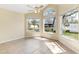 Sun-filled bedroom with multiple windows, neutral tile floors and a ceiling fan at 4486 Gaston St, Spring Hill, FL 34607