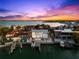 Aerial view of waterfront home featuring a pool and boat dock, ideally situated on the open bay at 517 Belle Isle Ave, Belleair Beach, FL 33786