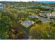 Aerial shot of outdoor basketball court surrounded by lush greenery, ideal for sports and recreation at 517 Belle Isle Ave, Belleair Beach, FL 33786