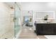 Bathroom featuring glass shower, dual vanity, and views of the waterfront bedroom suite at 517 Belle Isle Ave, Belleair Beach, FL 33786