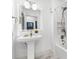 Bathroom with white vanity, framed mirror, and a shower over tub at 517 Belle Isle Ave, Belleair Beach, FL 33786