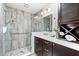 Beautiful bathroom features a glass door shower, elegant tiles and modern vanity at 517 Belle Isle Ave, Belleair Beach, FL 33786