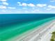 Stunning aerial view of the beach featuring turquoise water and white sand, offering a tranquil escape at 517 Belle Isle Ave, Belleair Beach, FL 33786