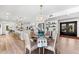 Dining room leading to a modern kitchen with an island and barstool seating at 517 Belle Isle Ave, Belleair Beach, FL 33786