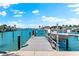 Dock with boat ready to explore the serene waterfront, perfect for boaters and water enthusiasts at 517 Belle Isle Ave, Belleair Beach, FL 33786
