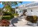 Charming walkway leading to the front door of this well-maintained home surrounded by mature landscaping at 517 Belle Isle Ave, Belleair Beach, FL 33786