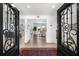 Elegant foyer with custom iron doors, wood floors, and views into the spacious living areas at 517 Belle Isle Ave, Belleair Beach, FL 33786
