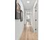 Long hallway with hardwood floors, modern lighting, and artwork on the walls at 517 Belle Isle Ave, Belleair Beach, FL 33786