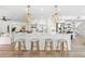 Bright, modern kitchen with a spacious island, pendant lights, and barstool seating at 517 Belle Isle Ave, Belleair Beach, FL 33786