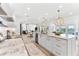Modern kitchen with island, marble countertops, and open layout to dining and living spaces at 517 Belle Isle Ave, Belleair Beach, FL 33786