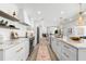 Modern kitchen with marble countertops, open shelving, and stainless steel appliances at 517 Belle Isle Ave, Belleair Beach, FL 33786