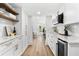Kitchenette with white cabinets, stainless steel appliances, and modern finishes at 517 Belle Isle Ave, Belleair Beach, FL 33786