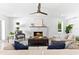 Inviting living room featuring a stone fireplace and ample seating with neutral tones at 517 Belle Isle Ave, Belleair Beach, FL 33786