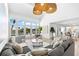 Bright living room with soaring ceilings, ample windows, stylish furnishings, and serene water views at 517 Belle Isle Ave, Belleair Beach, FL 33786